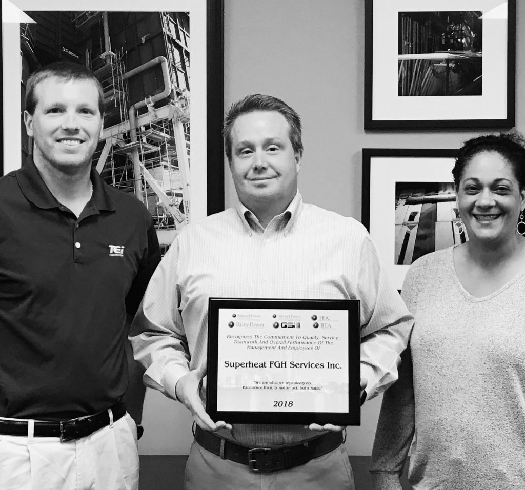 Superheat employees with an award for heat treatment